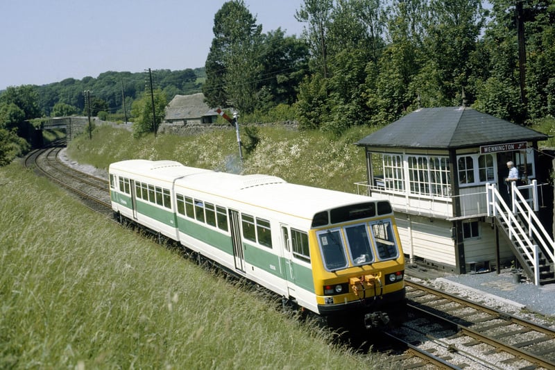 A new diesel railcar passes Wennington box on a crew training run to Carnforth in July 1984.