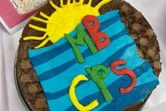 The winning chocolate cake at the Morecambe Bay Primary School cake baking competition was described as absolutely delicious with a fudgy texture and displayed the school logo.