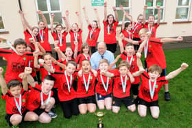 We are the champions.. .pupils from Lancaster Road Primary School celebrate winning the 2014 Lancashire Sportshall Athletics with sports teacher Alan Main.