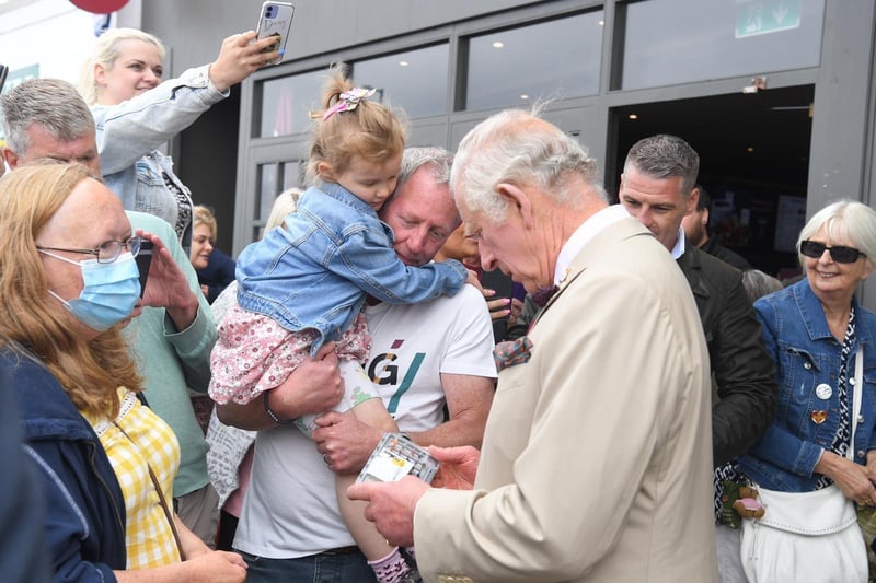 Prince Charles was handed a box of fishing flies by four-year-old Elizabeth Williams, whose family run the Troutflies UK shop.