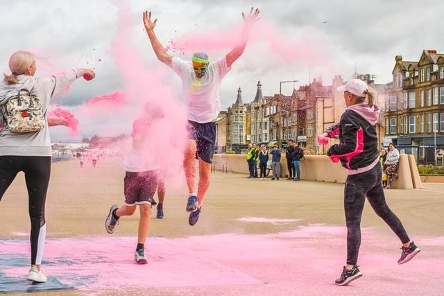 A colour dasher gets covered in pink paint powder.