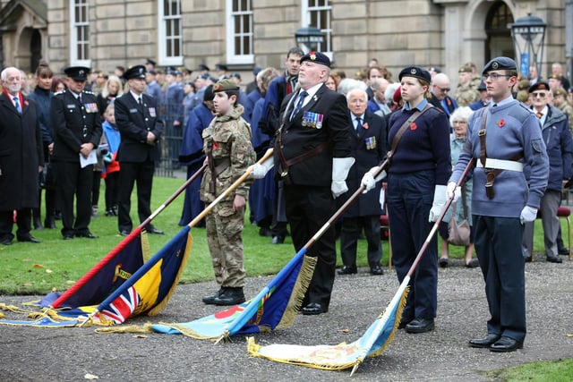 Standard bearers lower their flags on Remembrance Sunday in Lancaster.