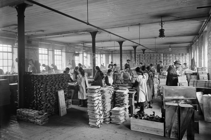 Workers, including girls, involved in the production of ammunition cases at the Lancaster Waring and Gillow factory. Photographer: H Bedford Lemere.
