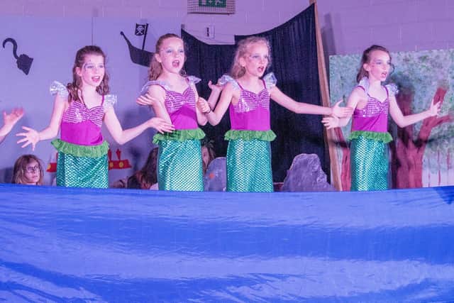 Children dressed as mermaids for their parts in the school summer musical Peter Pan.