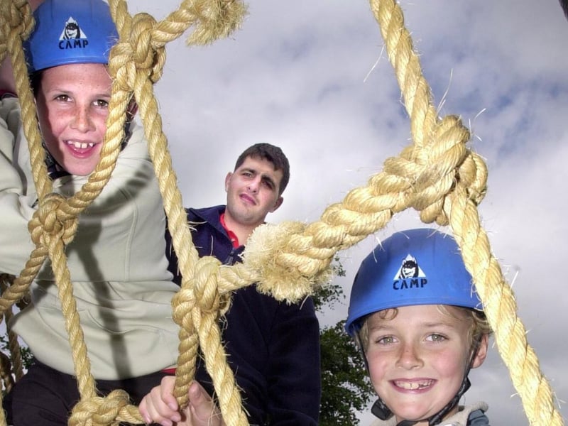 William Huntington and Adam Skelly from Torrisholme School having a great time on the King's Own Royal Border Regiment Assault course watched by Private Nelson.