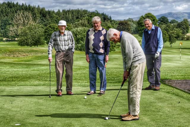 Geoff Hall on the practice putting green watched by (from left) Pat Hanson, Bob MacKeith and Phil Castle.