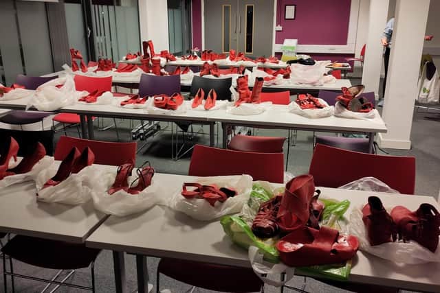 Red shoes being prepared for the exhibition.
