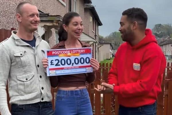 James and Amie Walling receive their prize from Danyl Johnson of the People's Postcode Lottery. Image from People's Postcode Lottery