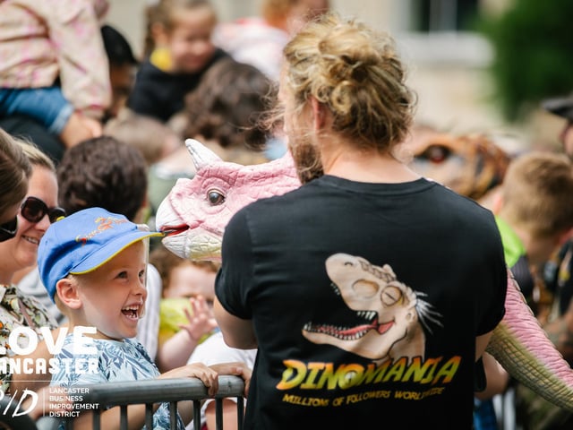 A boy greets a pink mini dinosaur at Dino Fest in Lancaster. Picture by Ginny Koppenhol.