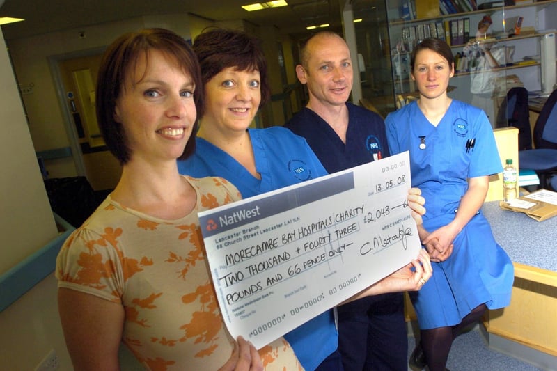 Claire Metcalfe presents a cheque worth £2,043.66p to Coronary Care at The Royal Lancaster Infirmary. Claire raised the money with a sponsored three-mile swim. Receiving the cheque are Staff Nurses Kim Shield and Anna Evans, and Charge Nurse John Douglas.