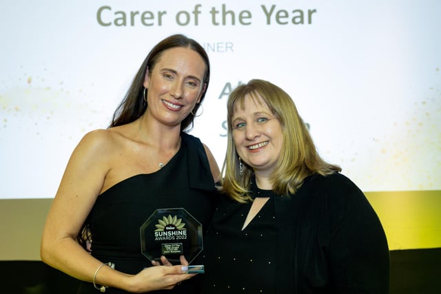 Carer of the Year Abbi Simpson (left) receives her award from Joanna Jeffreys, finance manager, St John's Hospice.