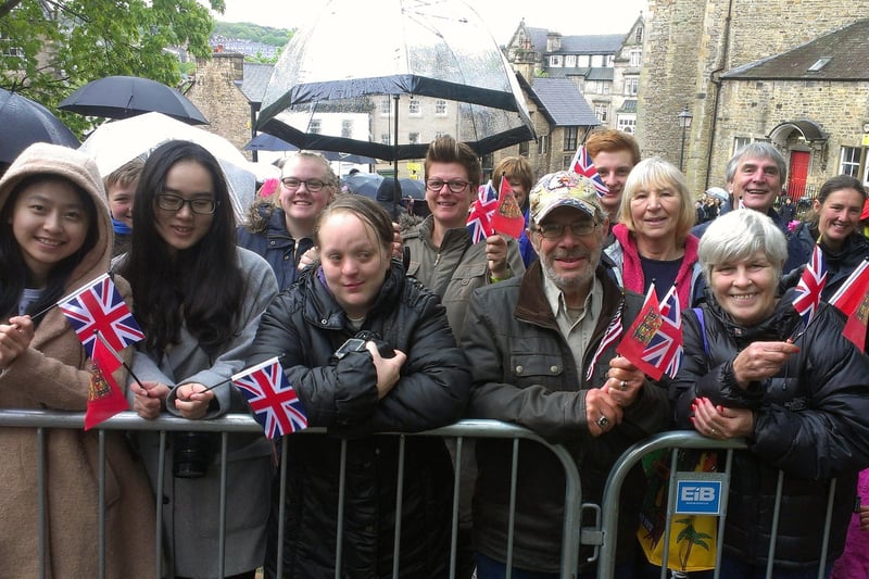 Crowds await the Queen's arrival on Castle Hill in Lancaster.