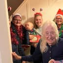 A MoralCare service user with the carol singing staff.