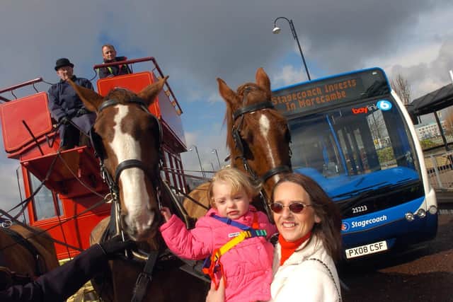 Edwina Houghton and her grandaughter Lauren Ridge stop to see the horses pulling Stagecoaches horse drawn bus. The spectacle was part of a launch ceremony at Morecambe Bus Station, of the company's new low level fleet of buses on the 6/6A Westgate route. This was in 2009.