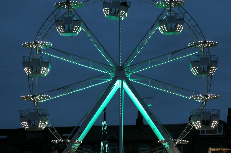 The illuminated ferris wheel on the promenade for Baylight '23.