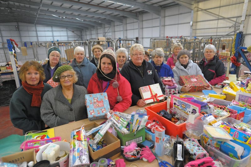 Operation Christmas Child area co-ordinator Anne Wardlaw (centre) with volunteers still busy packing boxes despite the theft of their van from their temporary home on White Lund.