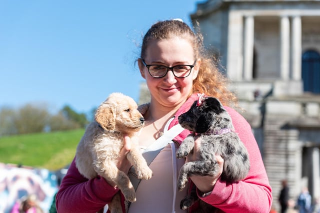 A woman holds two puppies at the Pups in the Park event in Williamson Park, Lancaster.