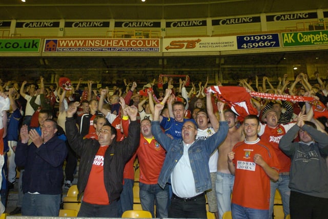 Morecambe fans celebrate at Wolverhampton after an amazing Carling Cup triumph.