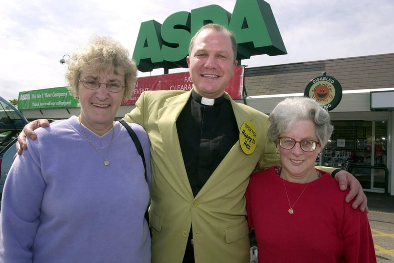 Vicar Gary Ingrim who was greeting Asda's customers as they entered and left the store is seen here giving a welcome hug to Linda Muckle and Pauline Corless.