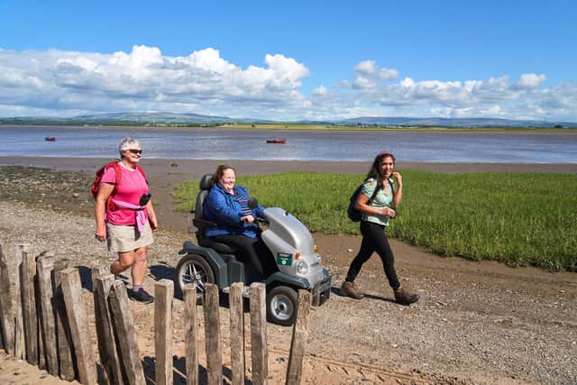 Walkers and person on an all-terrain mobility scooter (Tramper) at Sunderland Point. Picture by Wildey Media.