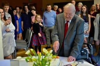 William Howson cutting the birthday cake. Photo by Edwin Howson.