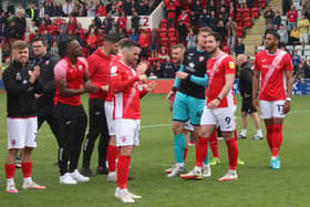 Morecambe's players celebrate the club securing League One status