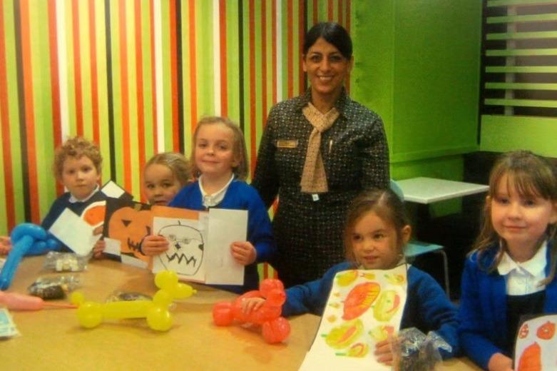 Customer care manager at McDonald's in Lancaster, Sara Taylor, presents Moorside Primary School pupils, Eric, Lucy, Rachel. Maddie and Charlotte, with meal vouchers for winning the Halloween colouring competition.