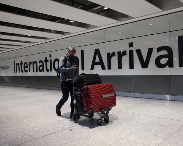 LONDON, ENGLAND - NOVEMBER 28: A man wears a face covering at Heathrow Terminal 5 on November 28, 2021 in London, England. Following the discovery of a new Covid-19 variant, whose mutations  suggest greater transmissibility than previous virus strains, the United Kingdom imposed new restrictions on arriving travelers. From 04:00 today, people arriving from South Africa, Botswana, Lesostho, Eswatini, Zimbabwe and Namibi, Malawi, Mozambique, Zambia, and Angola will face mandatory hotel quarantine. From Tuesday, all international travelers must isolate until they return a negative PCR test, which must be taken by Day 2. (Photo by Hollie Adams/Getty Images)