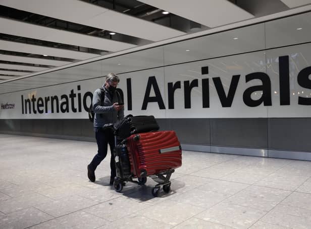 LONDON, ENGLAND - NOVEMBER 28: A man wears a face covering at Heathrow Terminal 5 on November 28, 2021 in London, England. Following the discovery of a new Covid-19 variant, whose mutations  suggest greater transmissibility than previous virus strains, the United Kingdom imposed new restrictions on arriving travelers. From 04:00 today, people arriving from South Africa, Botswana, Lesostho, Eswatini, Zimbabwe and Namibi, Malawi, Mozambique, Zambia, and Angola will face mandatory hotel quarantine. From Tuesday, all international travelers must isolate until they return a negative PCR test, which must be taken by Day 2. (Photo by Hollie Adams/Getty Images)
