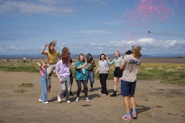 Young people celebrate helping to create a film to celebrate More Music's 30th anniversary.