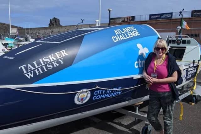 Vivienne Barclay next to the Talisker Whisky Atlantic Challenge craft.