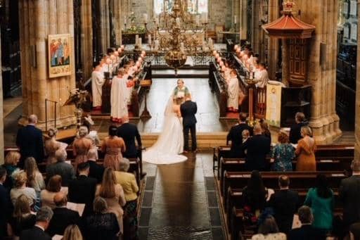 Michelle and Aaron's wedding ceremony at Lancaster Priory on Coronation Day. Photo by James Hicks Photography