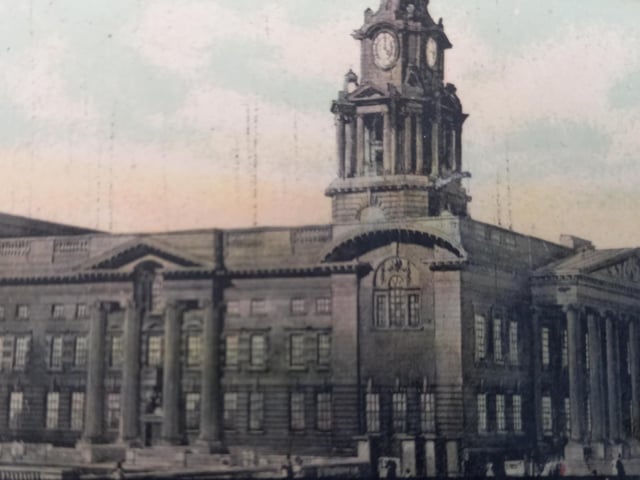 A side view of the then relatively new Lancaster Town Hall, built in 1909. The building was commissioned to replace the aging town hall, now the City Museum, in Market Square. The new building was designed by Edward Mountford and Thomas Lucas in the Edwardian Baroque style and the stonework, furniture and carvings were undertaken by Waring & Gillow. It accommodated a police station in the basement and a magistrates' court on the ground floor and it included an assembly hall, to the rear of the main building, which became known as the Ashton Hall.