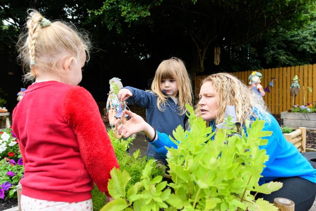 A Mossgate Day Nursery pupil picks out a carrot that was planted in the new outdoor space. Photo: Kelvin Stuttard
