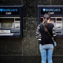 A customer uses an ATM machine outside a branch of a Barclays bank in central London. (Photo by Tolga Akmen / AFP) (Photo by TOLGA AKMEN/AFP via Getty Images)