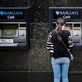 A customer uses an ATM machine outside a branch of a Barclays bank in central London. (Photo by Tolga Akmen / AFP) (Photo by TOLGA AKMEN/AFP via Getty Images)