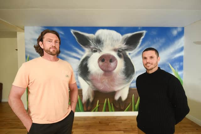 Artist Seca One has painted a mural on a wall at Farmer Parr's of popular kunekune pig, Flower. He is pictured with farm manager Lee Whitehead.