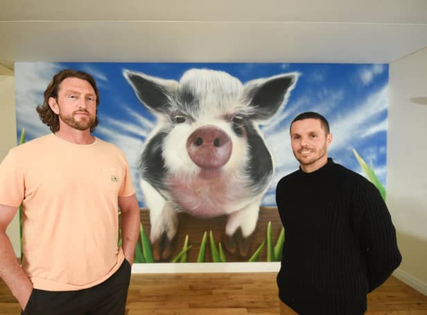 Artist Seca One has painted a mural on a wall at Farmer Parr's of popular kunekune pig, Flower. He is pictured with farm manager Lee Whitehead.
