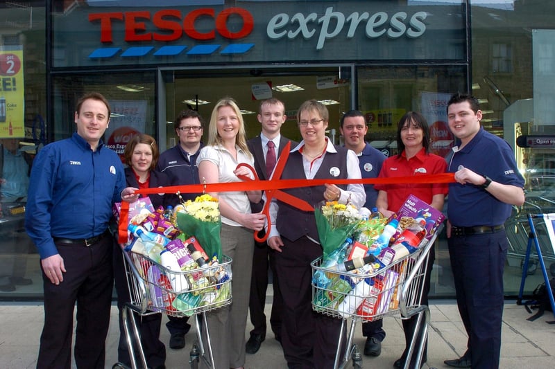 Head of fundraising at St John's Hospice, Catherine Butterworth, cuts the ribbon to open the Tesco Express Lancaster in the new Travelodge building on King Street, watched by staff and store manager, Clare Hisom, who also presented a cheque for £500 towards the quiet family room at the hospice.