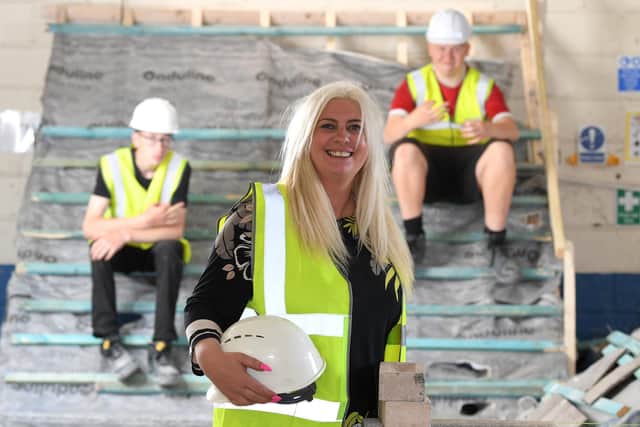 Carly lost her arm in a car accident and supports 'challenging' young adults to go into construction apprenticeships