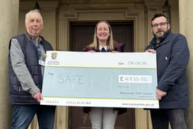 Keeley Wilkinson, founder of SAFE, is presented with a cheque for £4,930 by Morecambe town councillors John Livermore and Clark Kent.