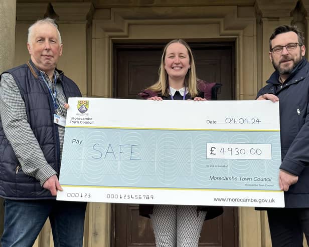 Keeley Wilkinson, founder of SAFE, is presented with a cheque for £4,930 by Morecambe town councillors John Livermore and Clark Kent.