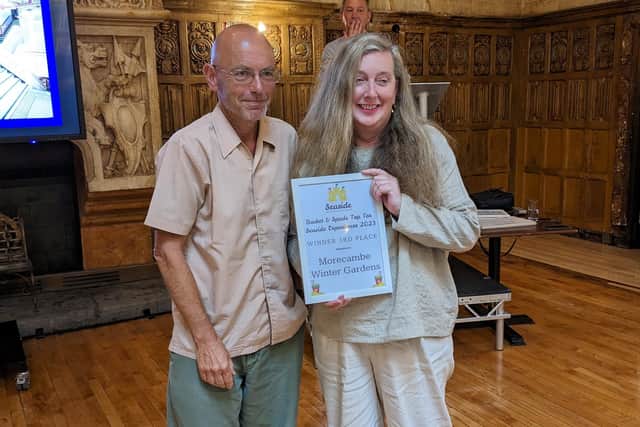 Prof Vanessa Toulmin, chair of the Morecambe Winter Gardens Preservation Trust, collects the award from Wayne Hemingway.