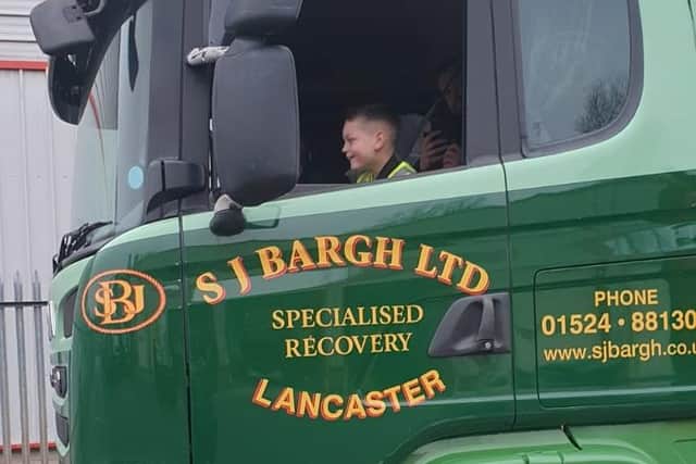 Luca Murray rides in one of the SJ Bargh trucks during his visit.