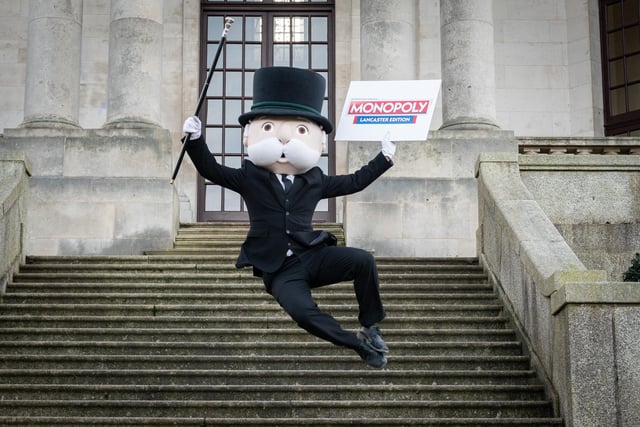 Mr Monopoly jumps for joy at the launch event of Lancaster's edition of Monopoly on the steps of Ashton Memorial in Williamson Park.