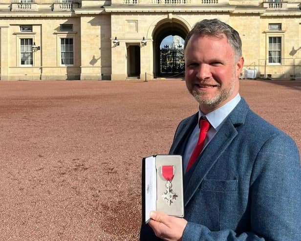 Dr Andy Knox at Buckingham Palace, where he received his MBE from King Charles III.