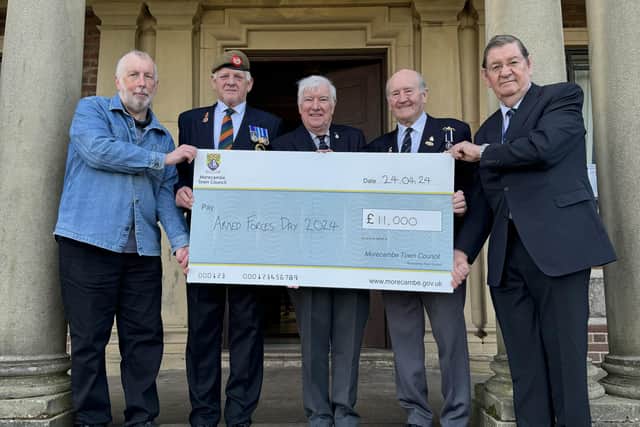 Morecambe Town Councillors present a cheque for £11,000 to representatives from Morecambe & Lancaster Armed Forces Day. From left: John Livermore, Mal Neill, Tim Roberts, Jim Halliwell, Roger Dennison.