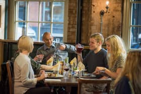 Customers enjoying food and drink in a Greene King pub.