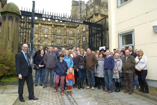 Manager of the Shire Hall and Lancaster Castle, Colin Penney, with the first group to be taken on a guided tour of Lancaster Castle Prison when it opened its gates to the public.