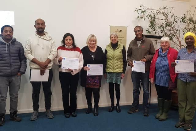 Some of the Global Link volunteers holding their Certificates of Achievement.